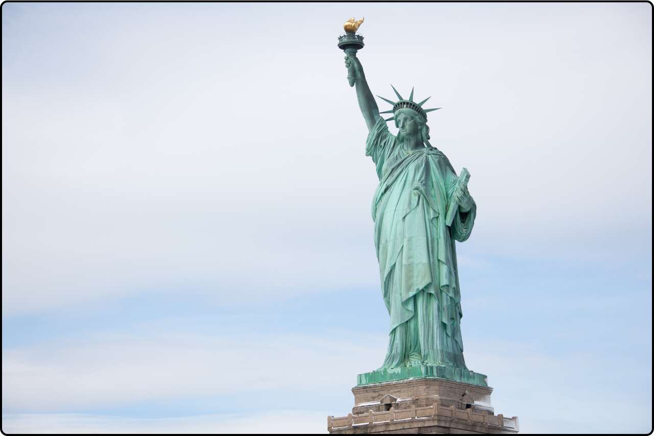 A historic monument, the Statue of Liberty, welcoming visitors to New York City.